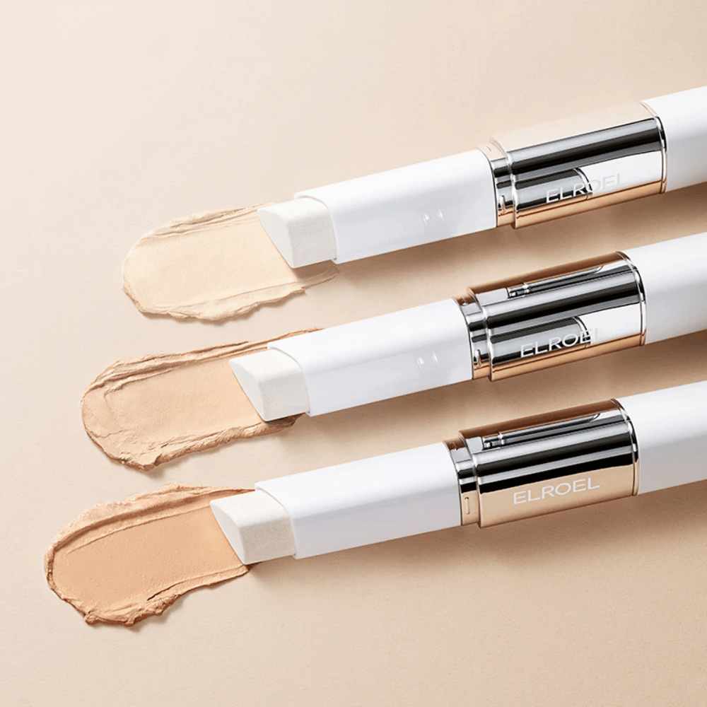 ELROEL Blanc Cover Cream Stick concealer avec pinceau intégré, plusieurs sticks alignés montrant le design du produit et l'application.