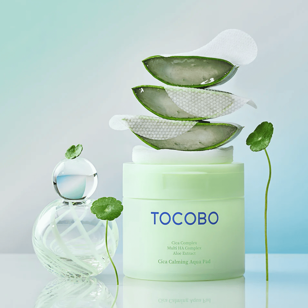 TOCOBO Cica Calming Aqua Pad est présenté avec des pads toner visage, de l’aloe vera et de la centella asiatica. L’image met en avant les ingrédients hydratants et apaisants du produit.
