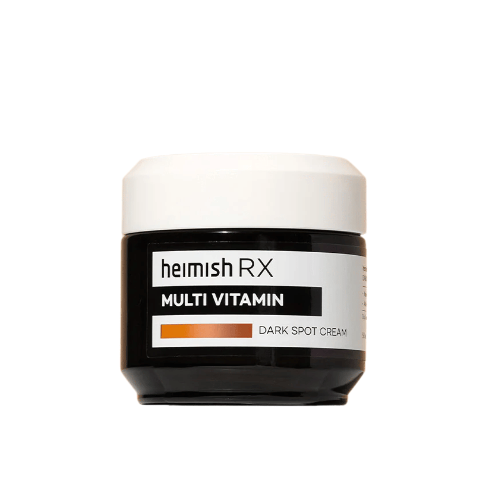 Heimish RX Multi Vitamin Dark Spot Cream dans un pot noir élégant avec un couvercle blanc. Une crème pour le visage enrichie en multivitamines, conçue pour réduire les taches sombres et uniformiser le teint.